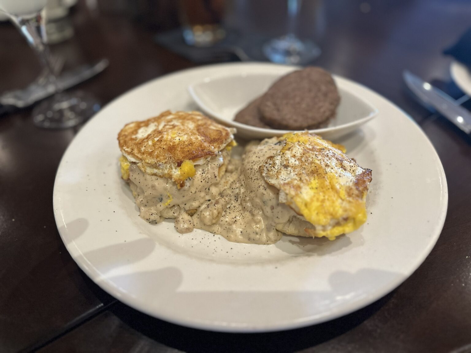 Smothered biscuits and gravy on a brunch table at Firebirds in Gainesville, Virginia.